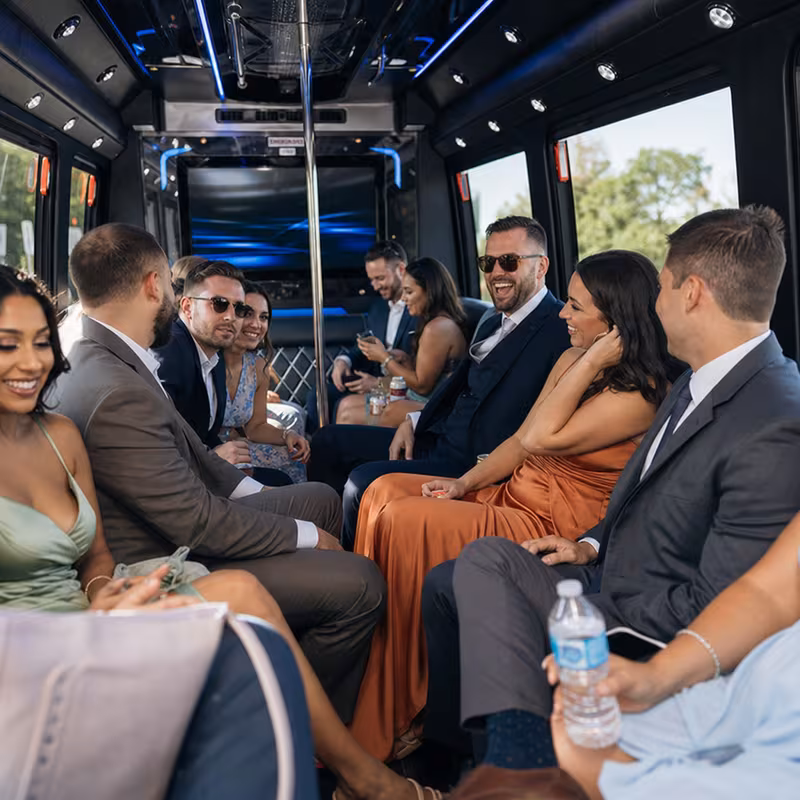 Wedding guests seated inside a Chicago party bus