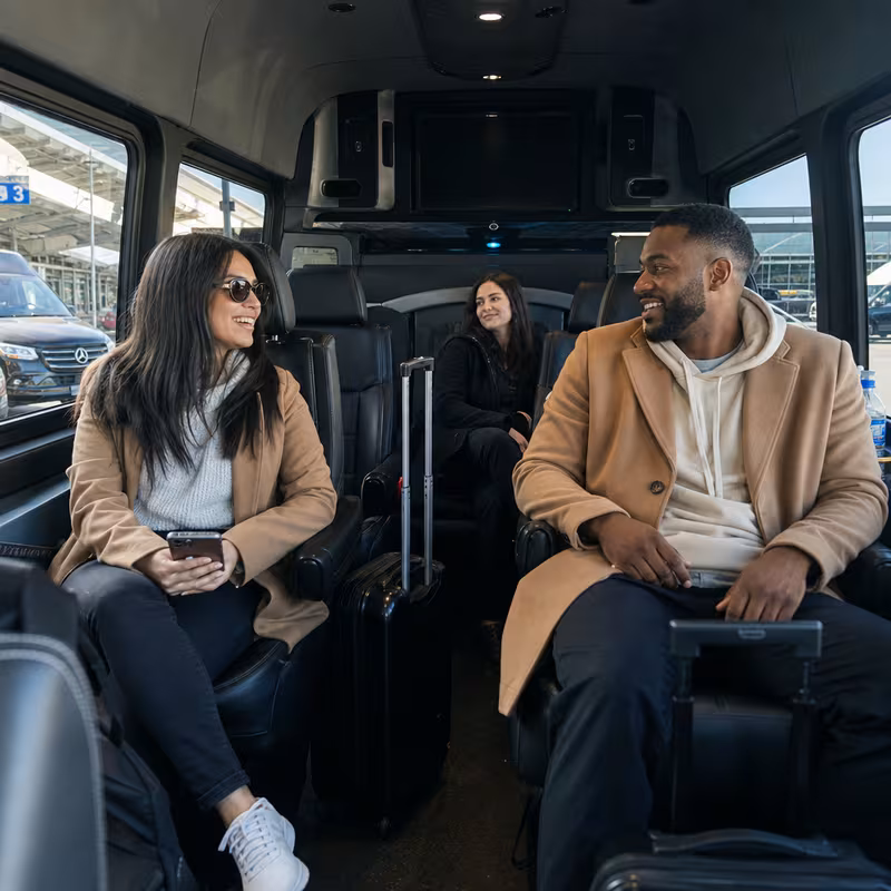 Passengers loading luggage while boarding an Chicago group shuttle
