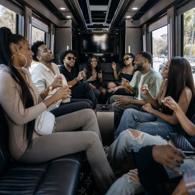 Group boarding a white charter bus for Concert Transportation transportation in Chicago
