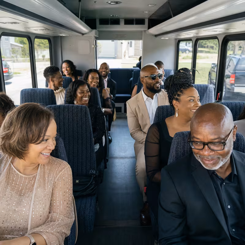 Group boarding a white charter bus for Private Event Transportation transportation in Chicago