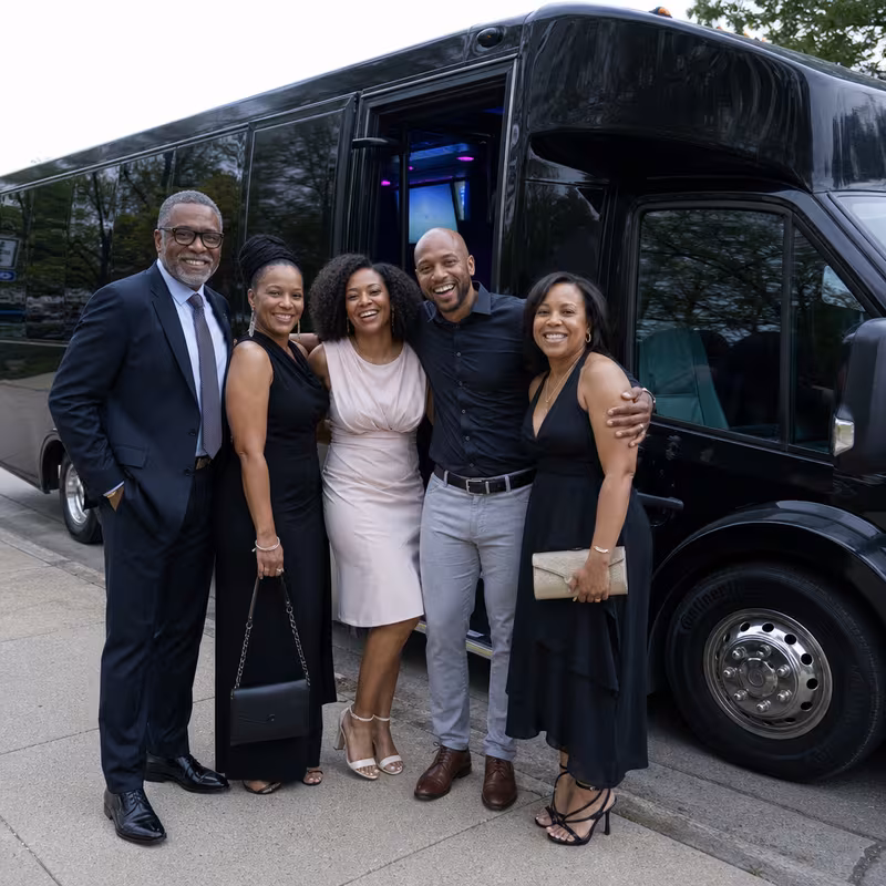 Passengers loading luggage while boarding an Chicago group shuttle