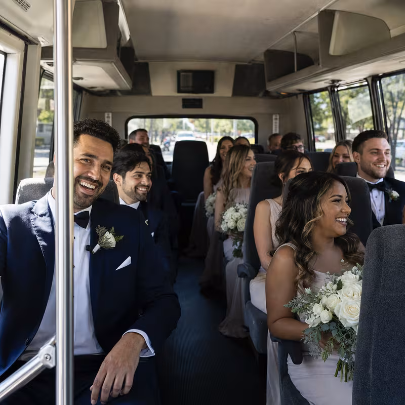 Group boarding a white charter bus for Wedding Transportation transportation in Chicago
