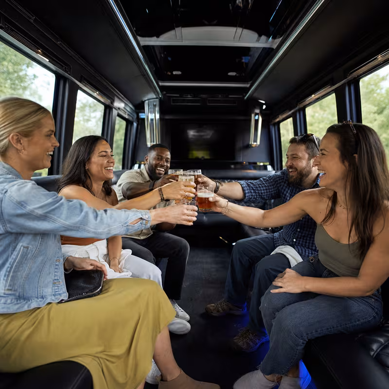Group boarding a white charter bus for Winery & Brewery Tour Transportation transportation in Chicago