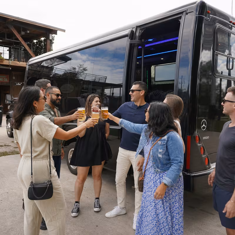 Passengers loading luggage while boarding an Chicago group shuttle